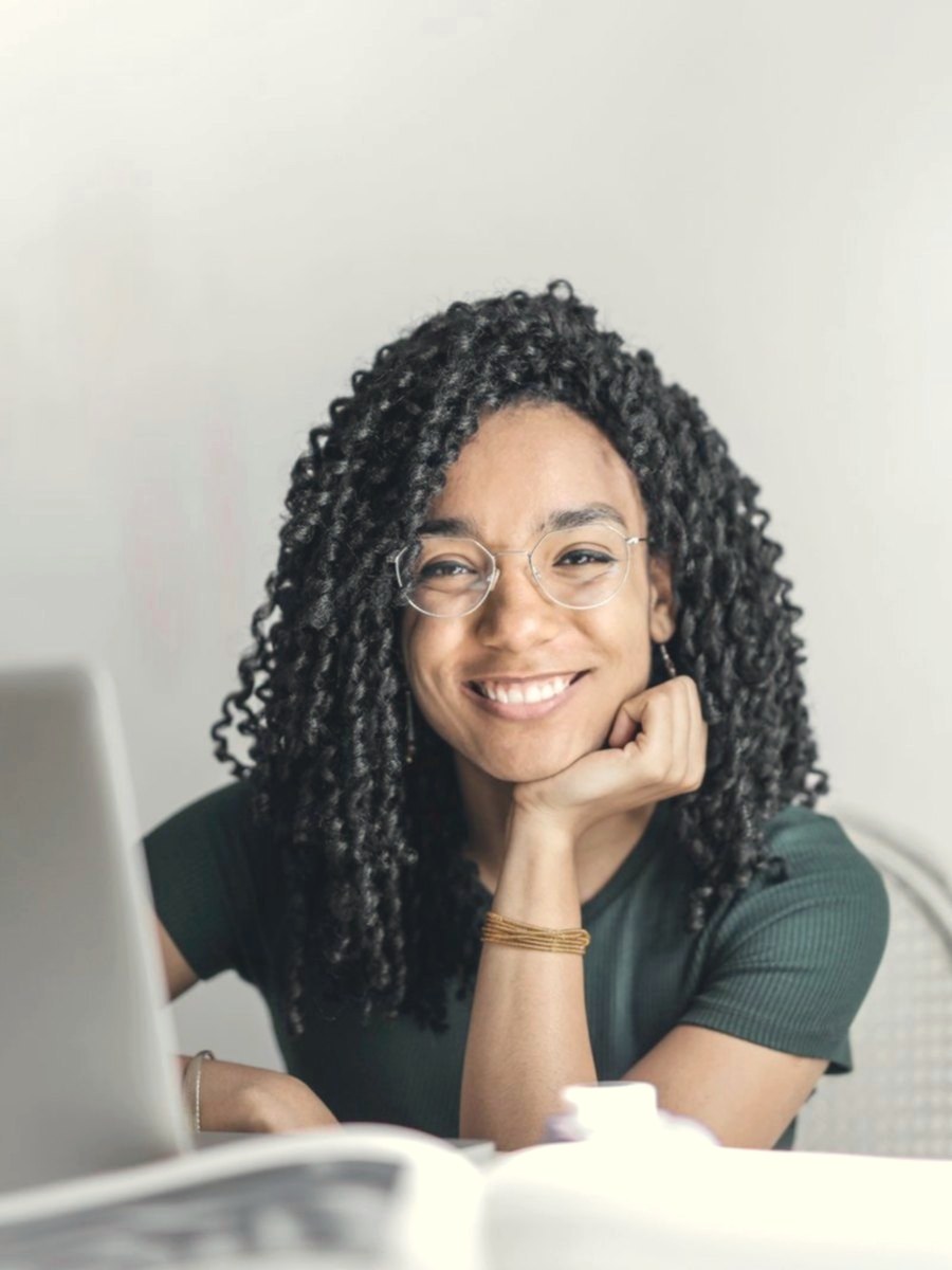 Example profile photo of a woman with glasses smiling gently